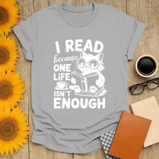Light gray tee featuring a cute cat in glasses reading, with the text 'I READ because ONE LIFE ISN'T ENOUGH' – perfect for book lovers!