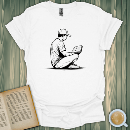 Unisex Reading in Serenity T-Shirt featuring a book lover enjoying a read, designed by BookedTees.