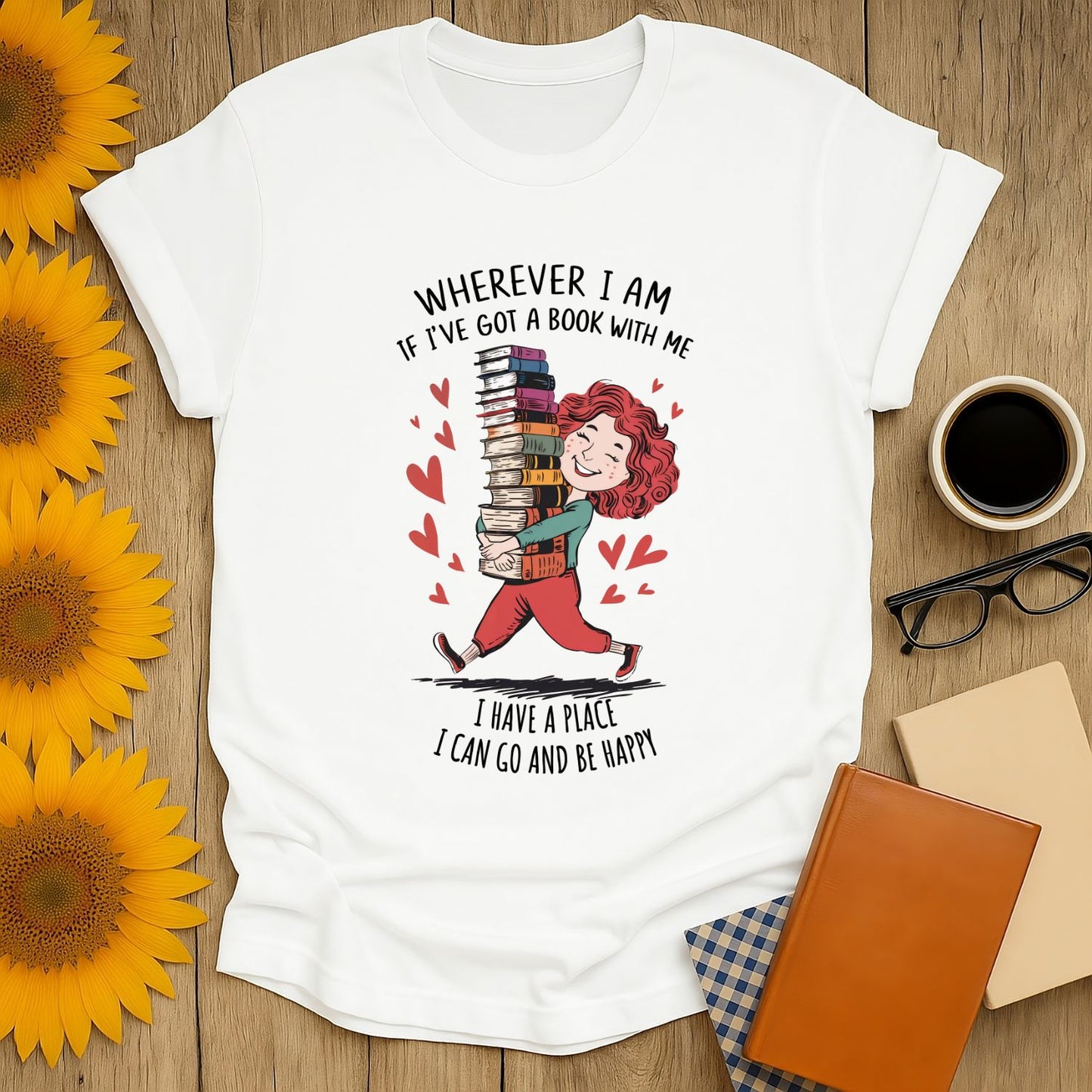 Book lover shirt featuring a joyful person with books, saying "Wherever I am, if I've got a book with me, I can go and be happy!" Perfect gift for readers!