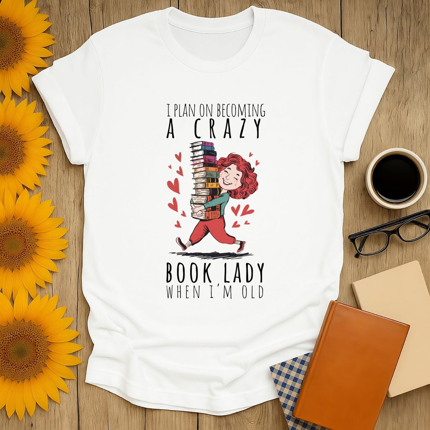 Cheerful unisex t-shirt with 'I plan on becoming a crazy book lady when I'm old' design, perfect for book lovers.