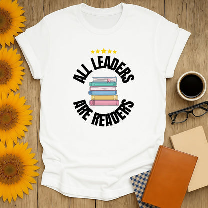 Unisex Leaders Are Readers T-Shirt with stacked books, perfect gift for book lovers who adore cats, coffee, and cozy reading.