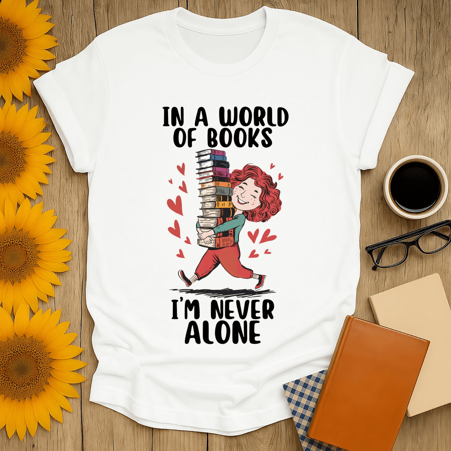 Never Alone with Books T-Shirt for book lovers featuring a playful design with a character holding stacked books.
