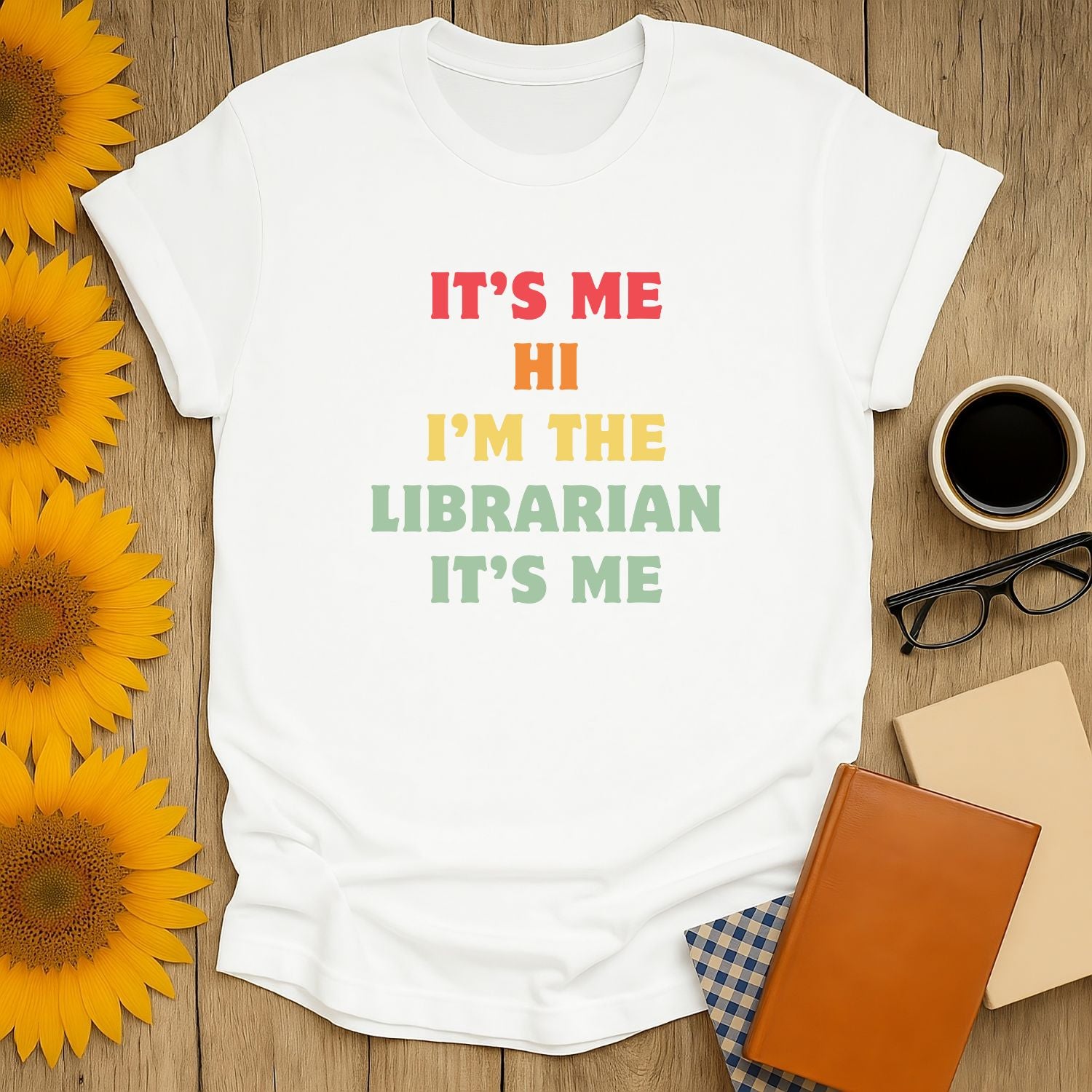 Funny librarian t-shirt featuring colorful text: "It's me, Hi, I'm the Librarian"—perfect cozy reading gift for book lovers.