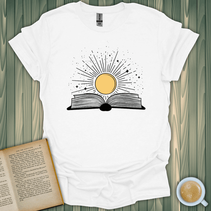 Sunshine Kiss T-Shirt featuring a sun over an open book design, perfect for book lovers. Made from 100% cotton.