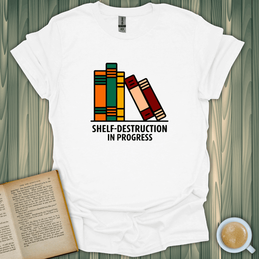 White unisex t-shirt with 'Shelf-Destruction In Progress' design featuring colorful stacked books, perfect for book lovers.