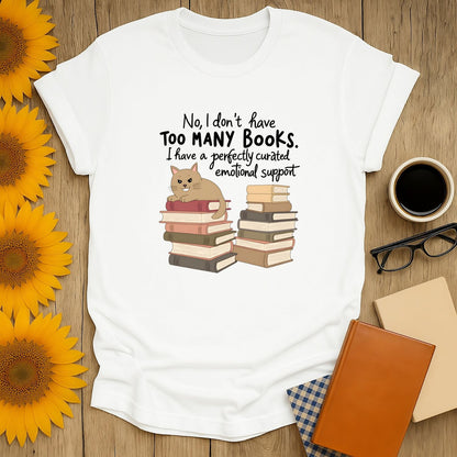 Funny book lover shirt featuring a cat atop stacked books and text, perfect for cozy reading with coffee or tea.