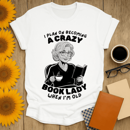 Crazy Book Lady t-shirt for book lovers featuring a woman reading with tea, perfect for any bibliophile.
