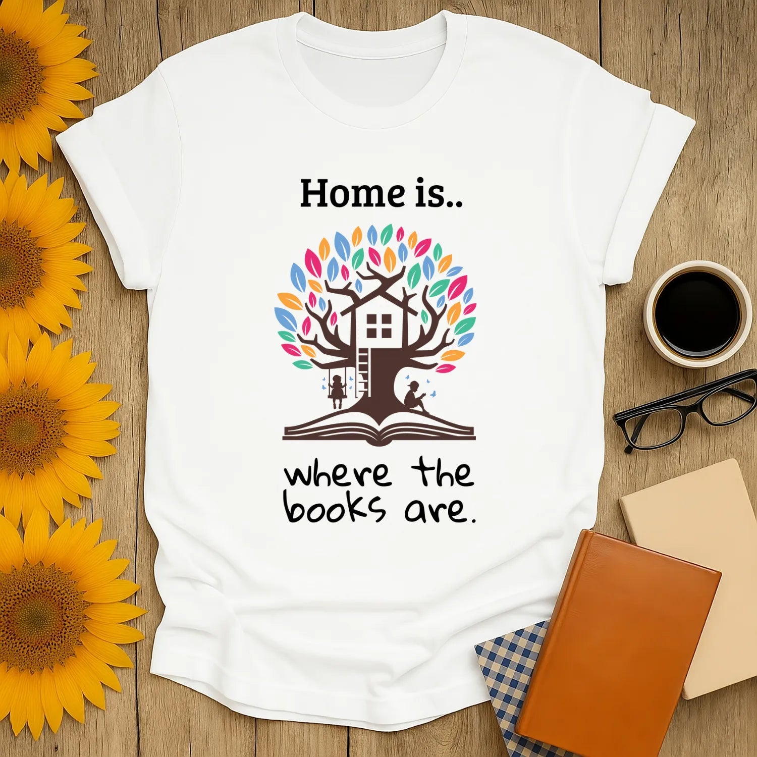 Cozy book lover shirt featuring a tree-house and the quote 'Home is where the books are,' perfect for readers and gift-giving!