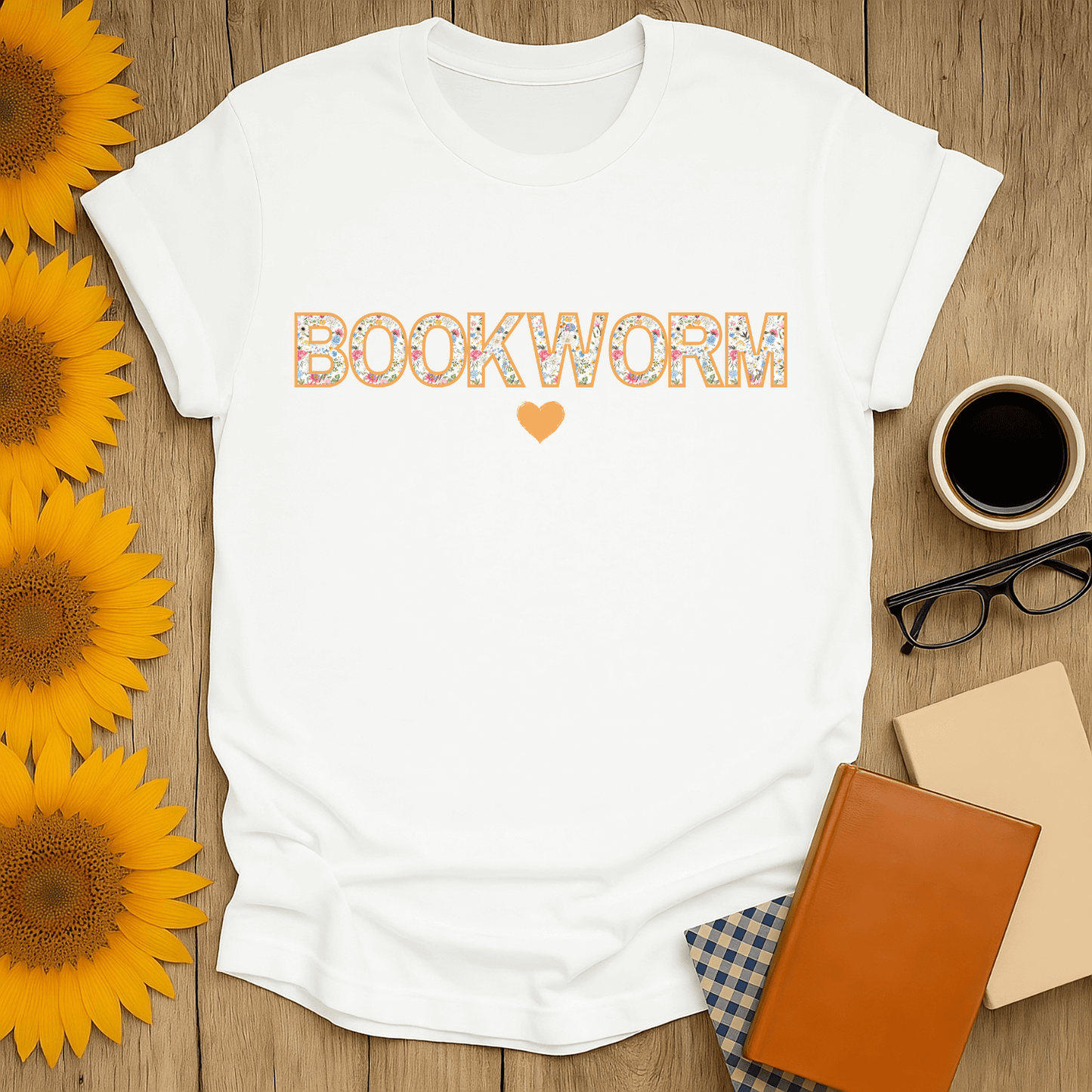Floral Bookworm T-Shirt design, white tee with "BOOKWORM" text, ideal for book lovers, featuring sunflowers and coffee.