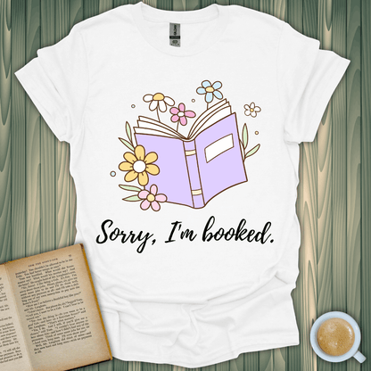 Sorry, I'm Booked t-shirt design with flowers and a book, perfect for book lovers. Unisex fit, 100% cotton.