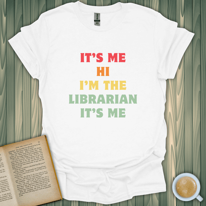 Librarian T-Shirt for book lovers, featuring colorful text saying "It's Me Hi I'm The Librarian" on a cozy, white fabric.