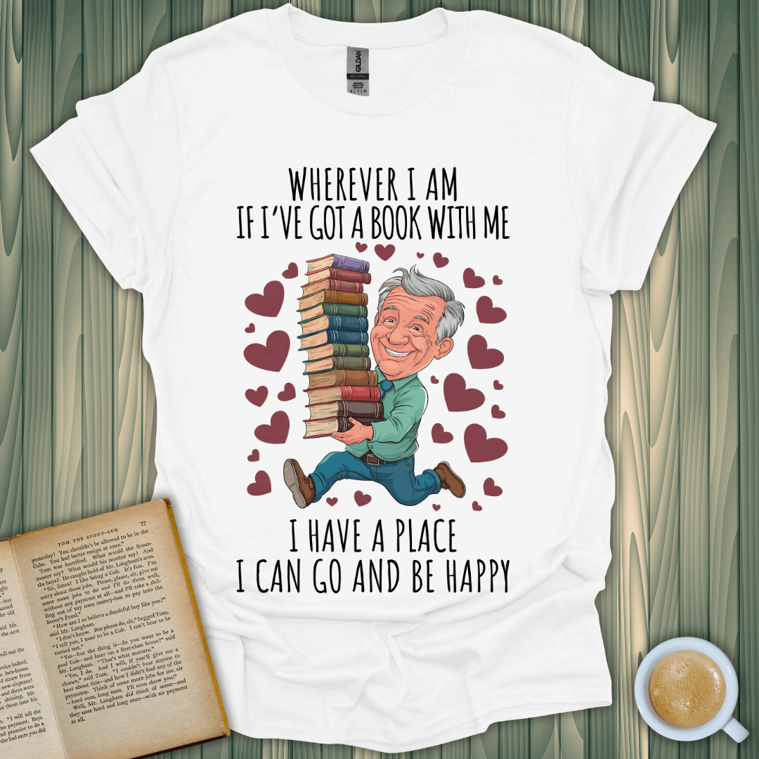 Wherever I Am book lover t-shirt featuring a happy person with stacked books and a fun, colorful design.