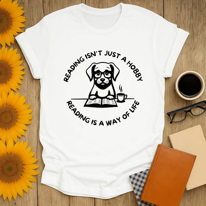 White t-shirt featuring a dog with the quote 'Reading isn't just a hobby, reading is a way of life.'