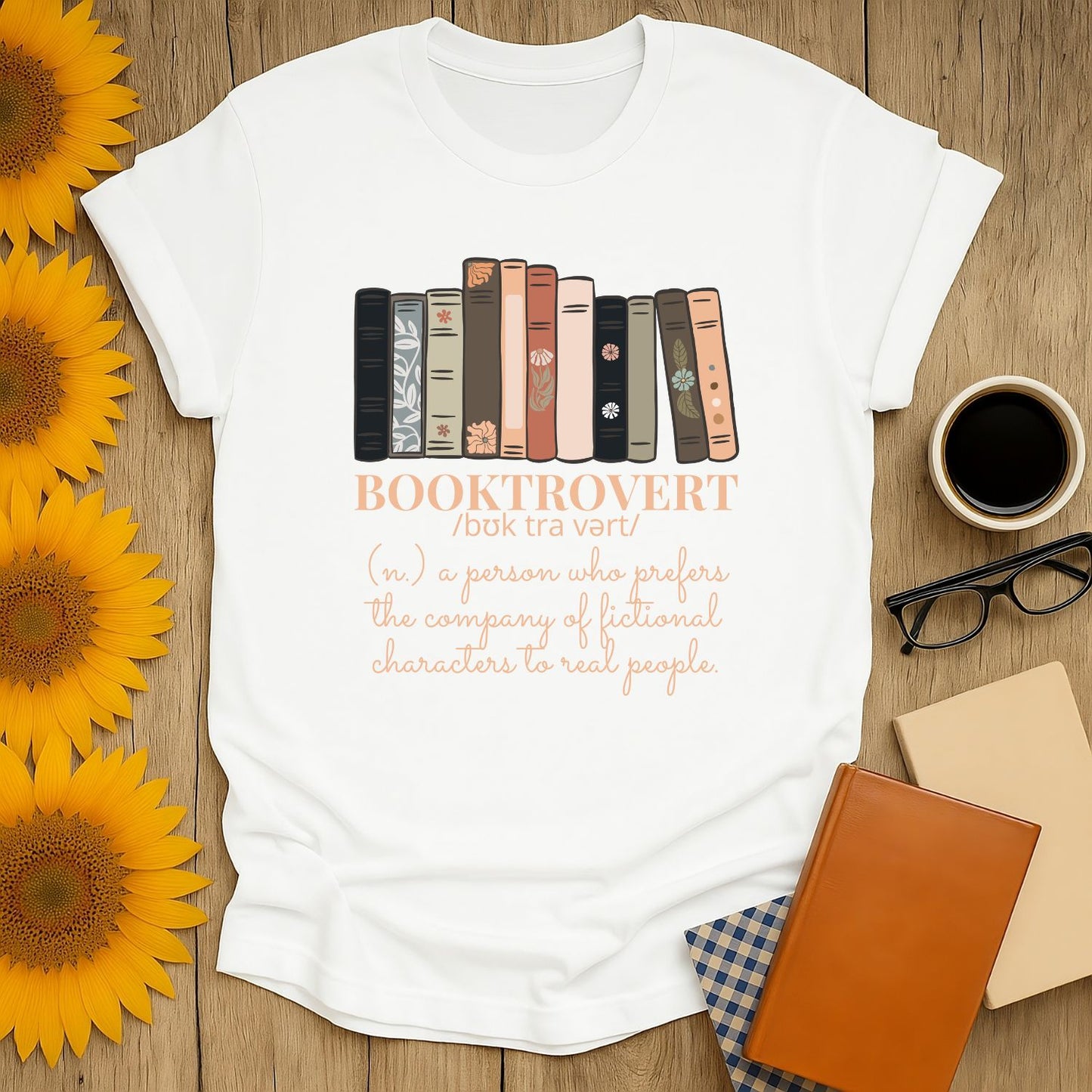 White Booktrovert T-shirt with stylish book stack and humorous text—perfect gift for cozy readers who love cats, coffee, and books!