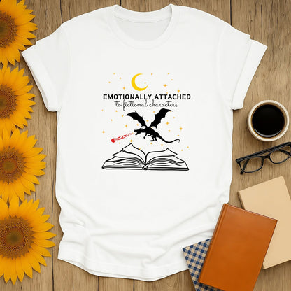 Emotional cat reading shirt with text 'Emotionally Attached to Fictional Characters', perfect for cozy book lovers.